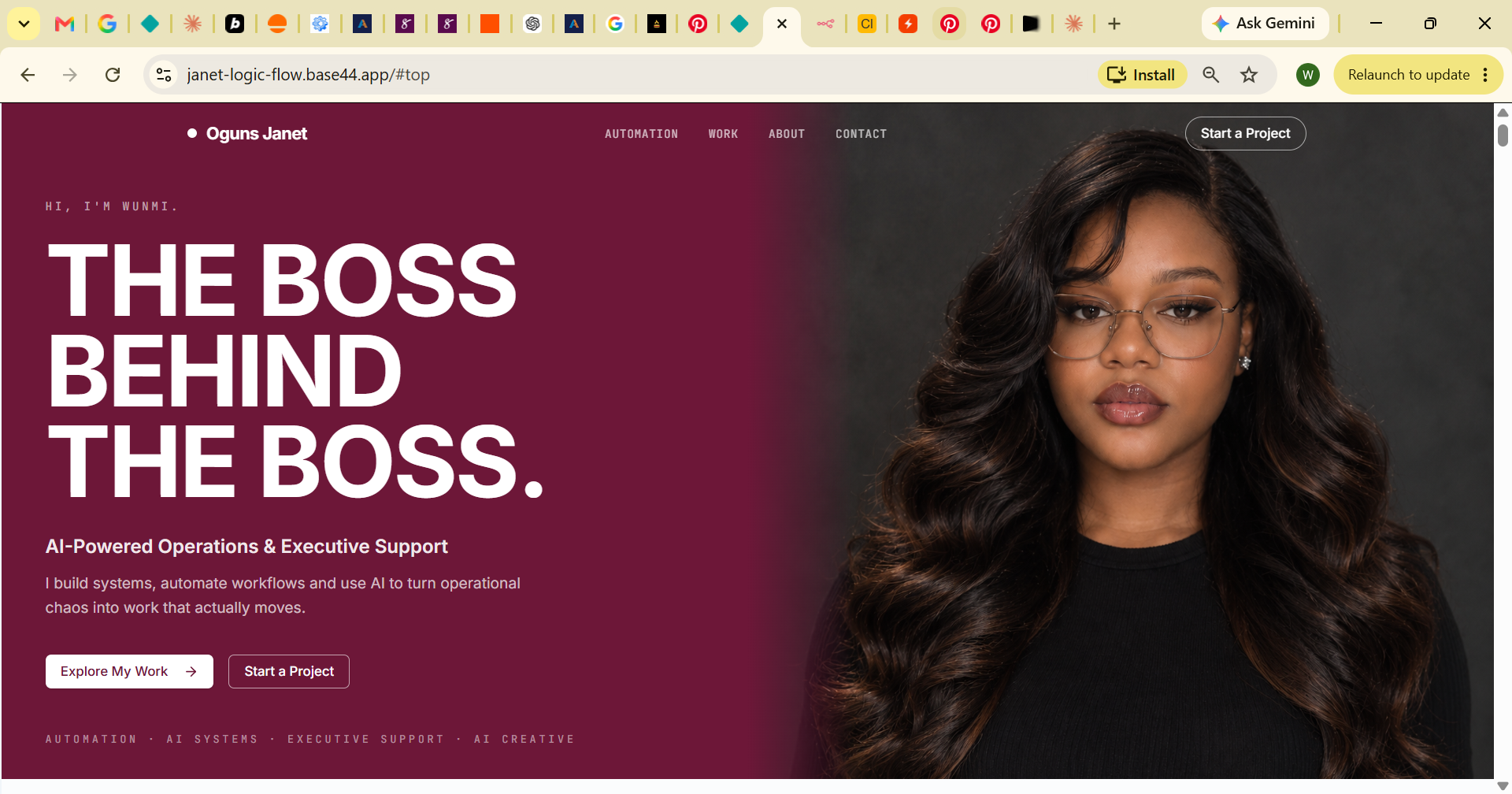 Wunmi wearing glasses and a black top against a dark studio background